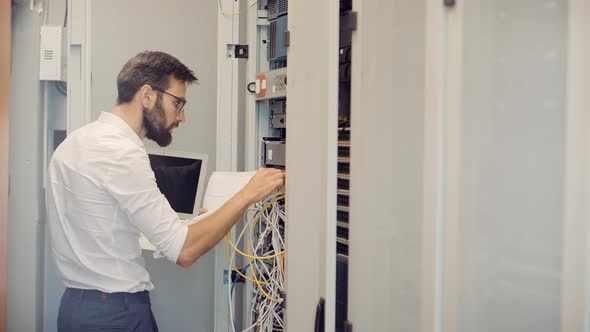 It Administrator In Mining Server Room And Connecting Ethernet Wire.Internet Network Switch Racks