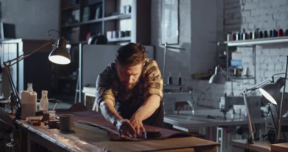 Male Artisan Measuring Leather on Table