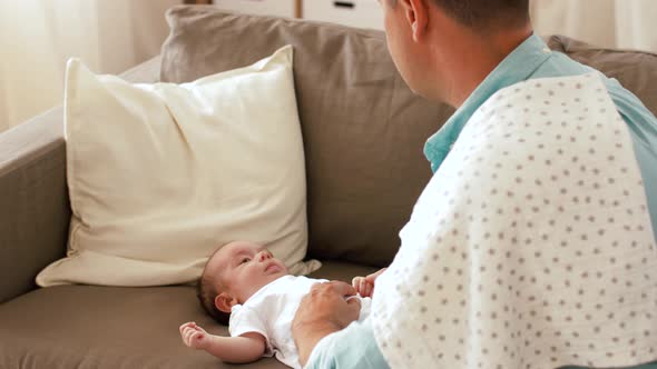 Middle Aged Father with Baby Daughter at Home