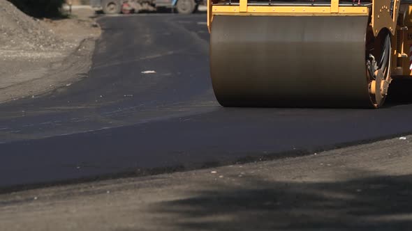 Roadway Repair. Asphalt Laying. The Roller Levels the Newly Laid Asphalt. Industrial Landscape with