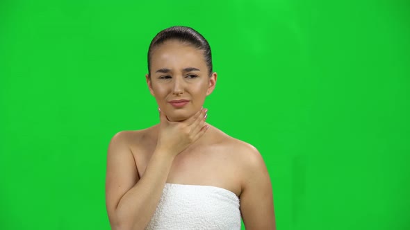 Young Woman in the Towel Gets Sick, She Has a Sore Throat, Cough, Fever. Green Screen