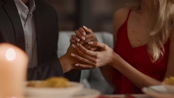 Loving Diverse Couple Holding Hands During Date In Restaurant Cropped