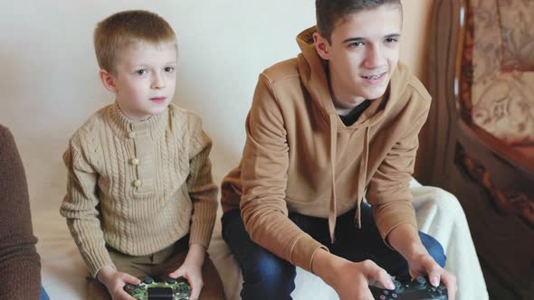 Children Play on the Console with Joysticks in Ruhs