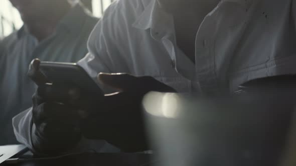 Man Using Smartphone in Cafe