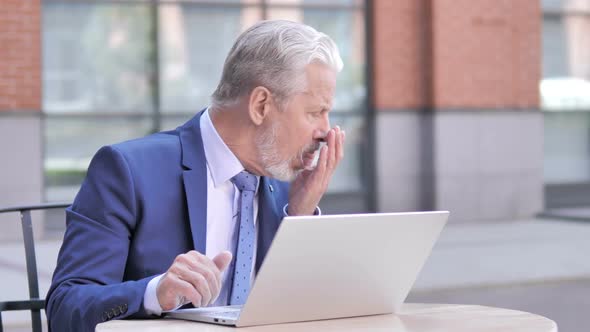 Sick Old Businessman Coughing While Working on Laptop Outdoor