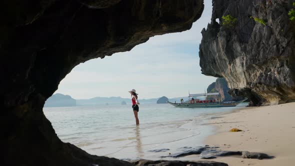 Woman Standing On Shore Of Entalula Beach