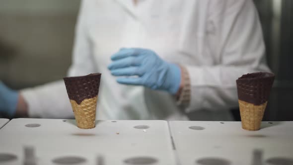 Ice Cream Production, the Worker Distributes Waffle-cones for Ice Cream on the Production Line