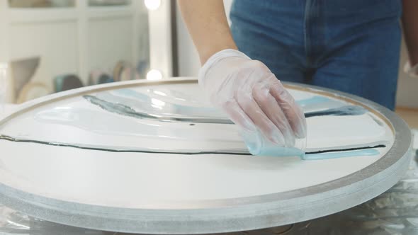 Pouring Pastel Blue Epoxy Resin Paint on the Round Surface