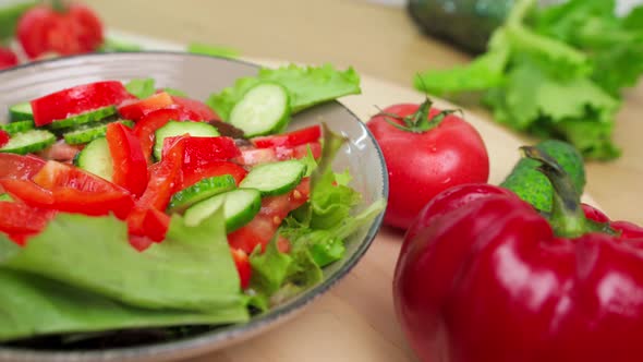 Fresh Vegetable Salad Close Up on a Wooden Tray Slow Motion