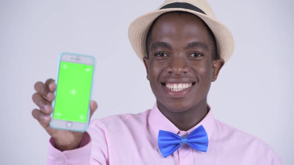 Face of Young Happy African Tourist Man Showing Phone