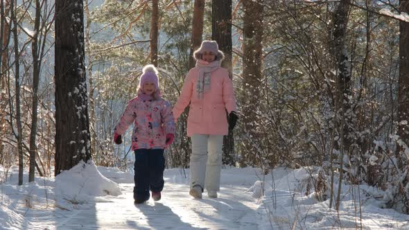 Girl Having Fun with Mom in Frosty Winter Day