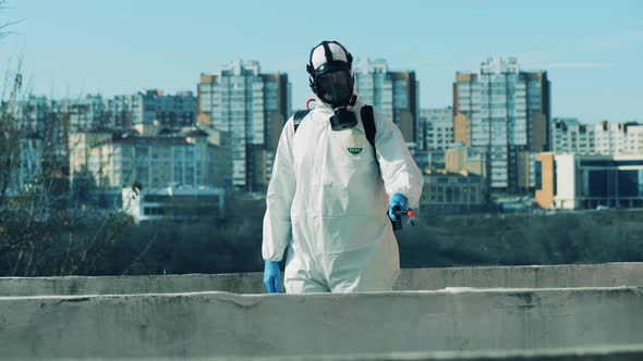 Disinfection Worker is Spraying Chemicals in the Street