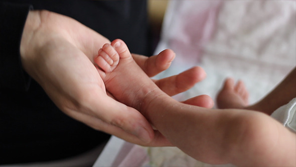 Mother Playing with Tiny Baby Foot