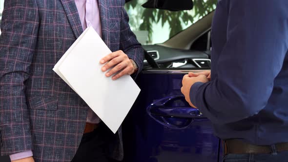 The Happy Buyer Receives the Keys To His New Car