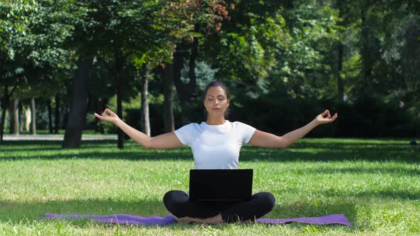 Woman Working with Laptop Sitting Lotus Pose, Yoga