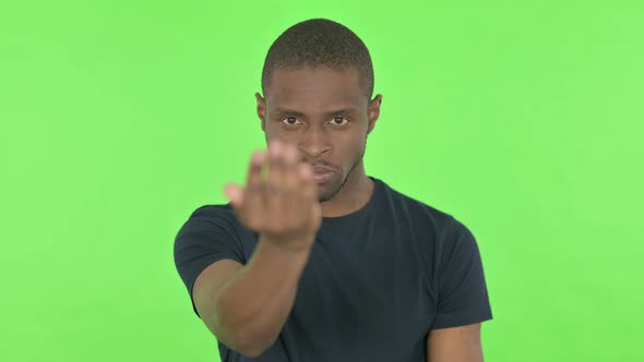 Angry Young African Man Ready for Fight Boxing on Green Background