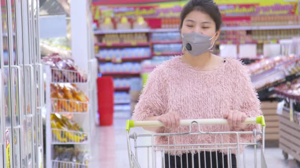 New normal lifestyle Asian mature adult female woman shopping in supermarket