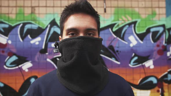 Portrait of Young Man Graffiti Artist on Graffiti Wall Background Close Up