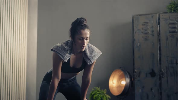 Fitness Woman Breathing and Resting During a Workout Pause at Home or Gym. Active Tired Woman Taking