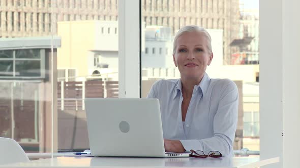 Mature Businesswoman Using Laptop in Office