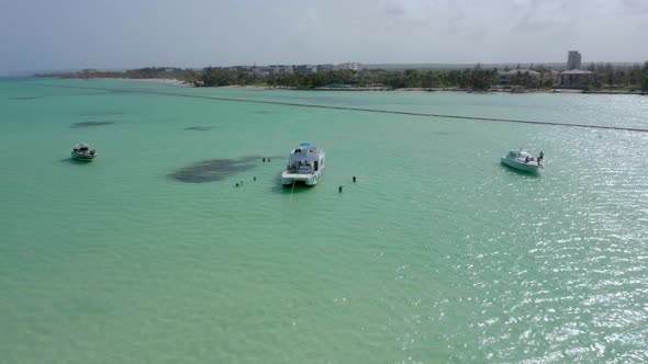 Spectacular paradise summer scene above turquoise ocean sea water by anchored motor boats offshore a