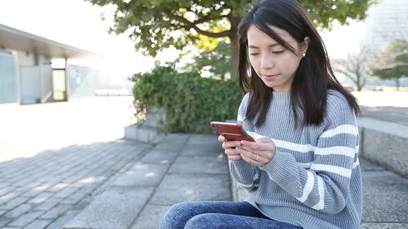 Woman using mobile phone at outdoor