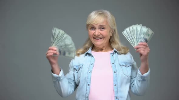Smiling Senior Woman Showing Dollar Banknotes, Quick Loan Service, Banking