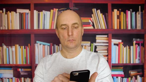 Man Using Smartphone in Library