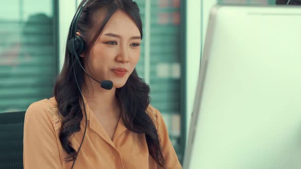 Businesswoman Wearing Headset Working Actively in Office