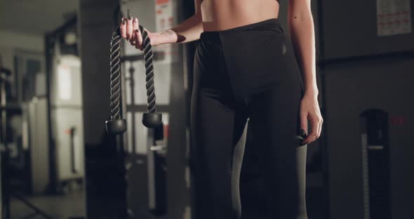 Female Athlete Holds a Sports Rope for Training in a Gym