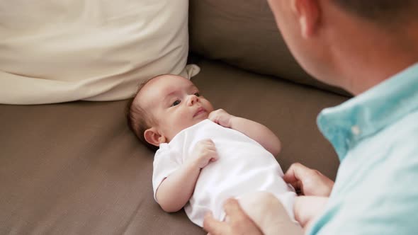 Middle Aged Father with Baby Daughter at Home