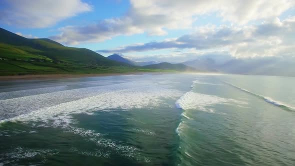 Repetitive sea waves and green hills 4k