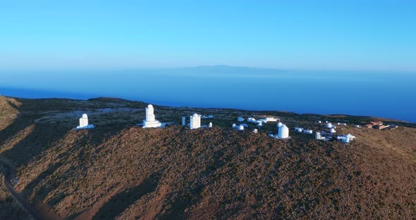 Aerial View. A Modern Astronomical Observatory in a Vast Meadow Valley. Big Open Space Landscape.