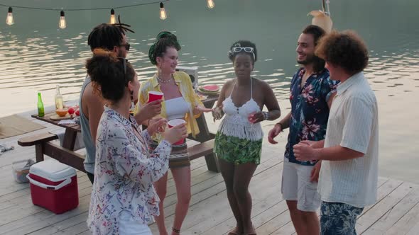 Diverse Friends Dancing on Wooden Pier at Lake Party