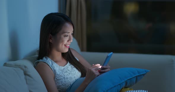 Woman look at smart phone at night