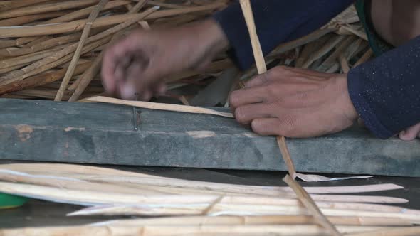 Medium Shot of a Woman Weaving Palm Tree Leaf