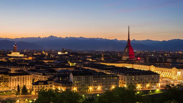 Timelapse day to night over Turin Italy, town wake up, colorful dramatic sky