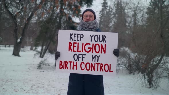 A person in a single picket with a Banner Keep My Religion Off My Birth Control