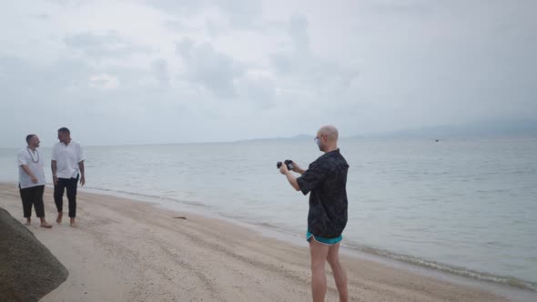 Photographer Take Pictures of a Gay Couple Walking Together By the Sea During Their Honeymoon