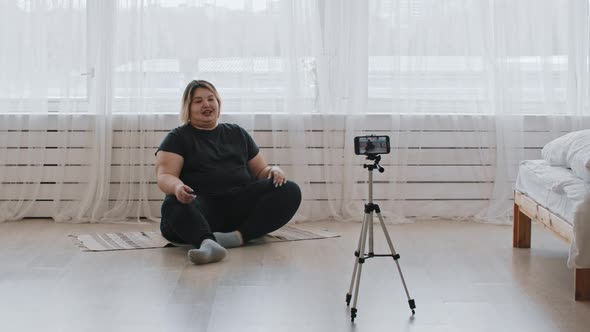 Cute Confident Overweight Woman Sitting on the Floor and Recording a Video for Her Followers