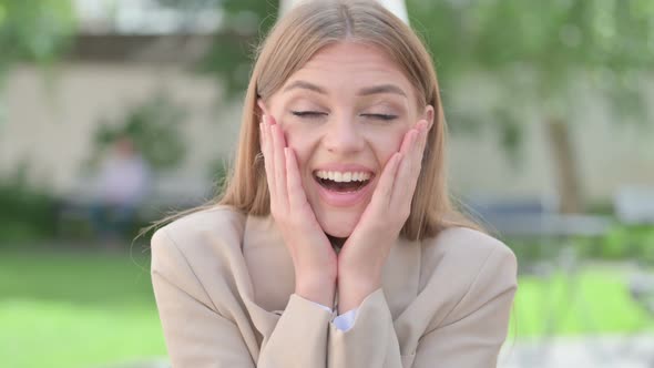 Outdoor Portrait of Young Businesswoman Feeling Surprised