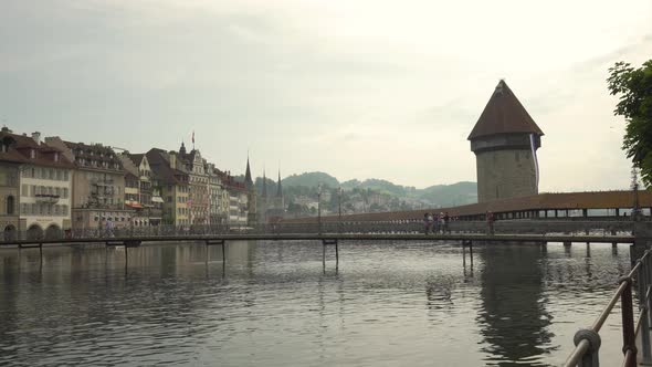 People walking on Chapel bridge at Lucerne, Switzerland. Zoom in