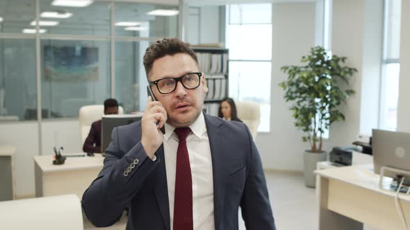 Business Executive Talking on Phone in Office