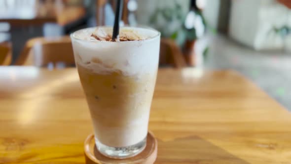 Stirring Creamy Foam Iced Cold Coffee Macchiato Drink at Cafe