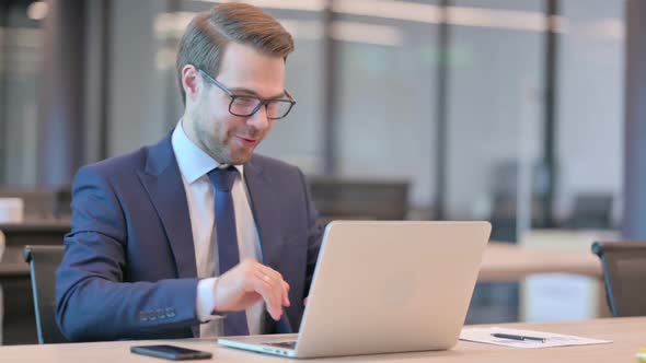 Businessman Talking on Video Call on Laptop