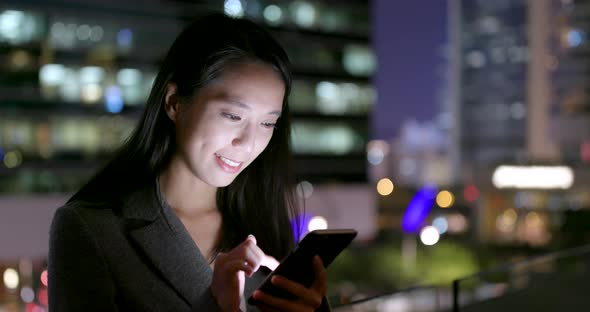 Business woman use of cellphone at night