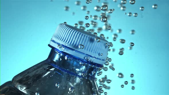 A Bottle of Water with Air Bubbles Under Water