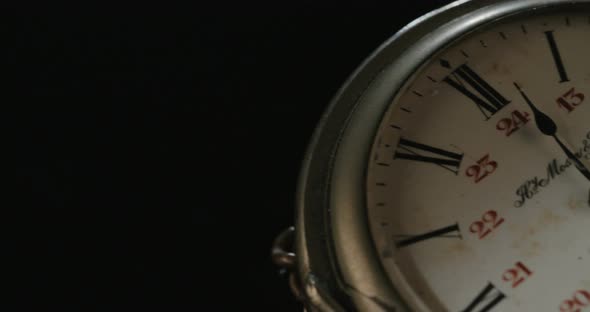 Macro shot of an antique pocket watch on a dark background