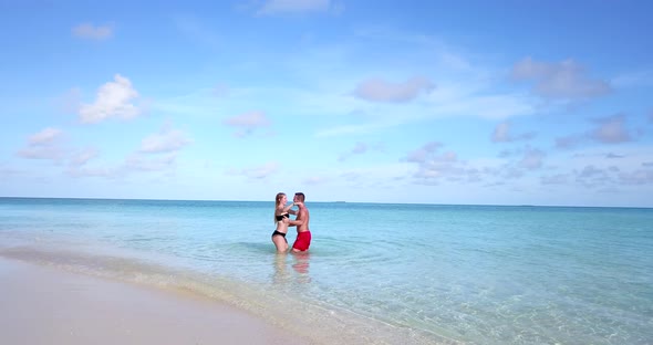 Happy couple after marriage in love live the dream on beach on white sand 4K background