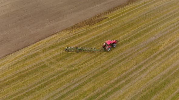 Tractor with Plow Turns on the Field